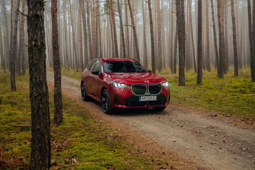 BMW X3 M50 in fire red in the forest