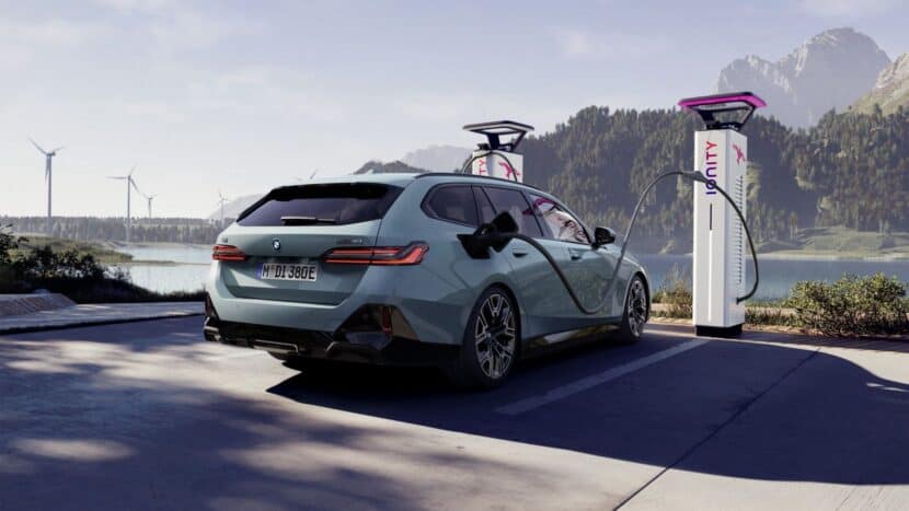 BMW i5 Touring charges at a charging station