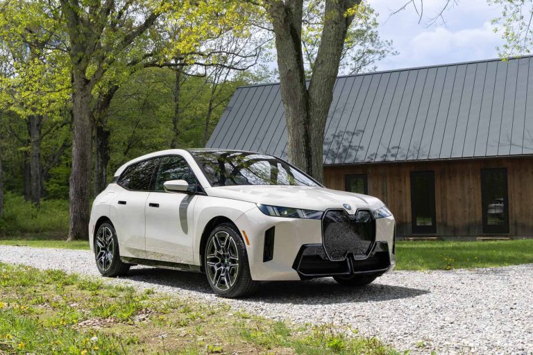 2026 BMW iX xDrive45 front three-quarter view with 21-inch wheels